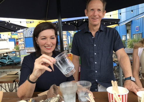 Environment Minister Leeanne Enoch and Eat Street’s John Harrison inspect cups made from corn starch and biodegradable utensils.