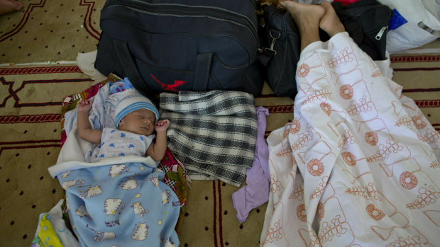 Ten-day-old Amdad Ahamed sleeps at a community centre, where his family has taken refuge in for fear of retaliation towards their community after the Easter Sunday bombings, in Pasyala, north east of Colombo, Sri Lanka.