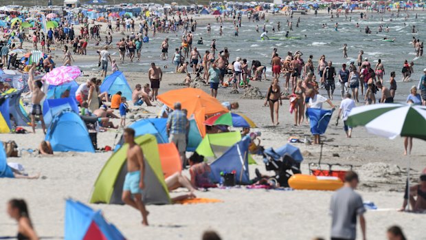 People crowd the beach at the Baltic Sea in Binz, Germany.