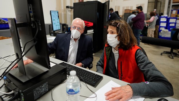 Democratic and Republican representatives review absentee ballots in Georgia's Fulton County.