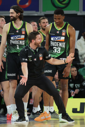South East Melbourne Phoenix coach Josh King speaks with forward Malique Lewis.