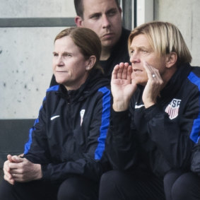 Tony Gustavsson in the dugout with USA coach Jill Ellis.