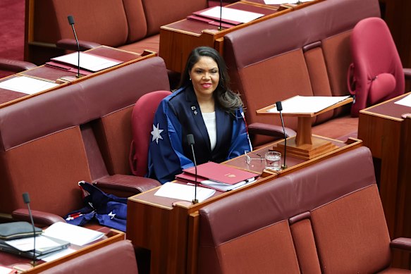 Senator Jacinta Nampijinpa Price draped in the Australian flag in the Senate for Flag Day last week.