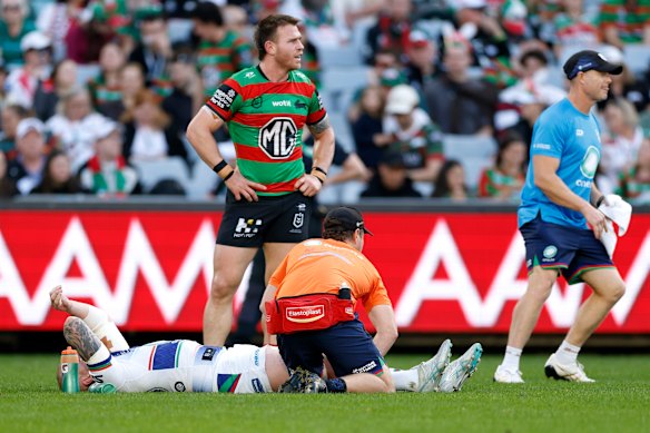 Warriors skipper Mitchell Barnett receives treatment on his injured knee on Sunday.