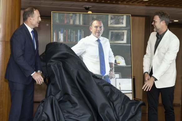 Former prime minister Tony Abbott unveils his portrait with artist Johannes Leak.