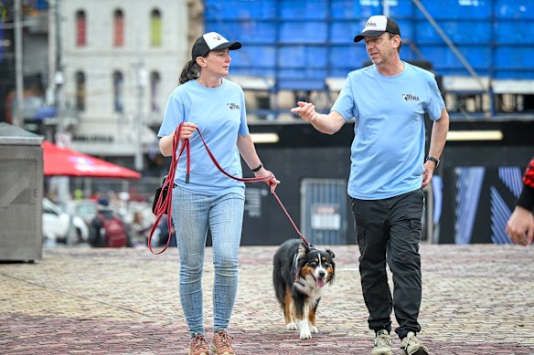 Tania McGregor at Federation Square with her seagull patrol dog Freya alongside James Webb, from dog walking business Mad Dogs & Englishmen.