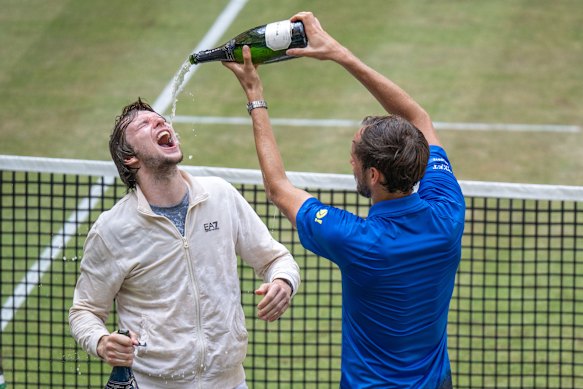 Alexander Bublik drinking champagne after winning the final in Halle last year.