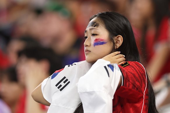 A South Korean fan watches on nervously.