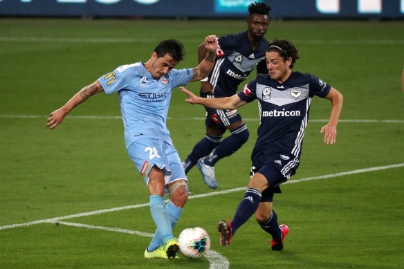 City's Adrian Luna and Marco Rojas of Melbourne Victory vie for possession in their derby clash.