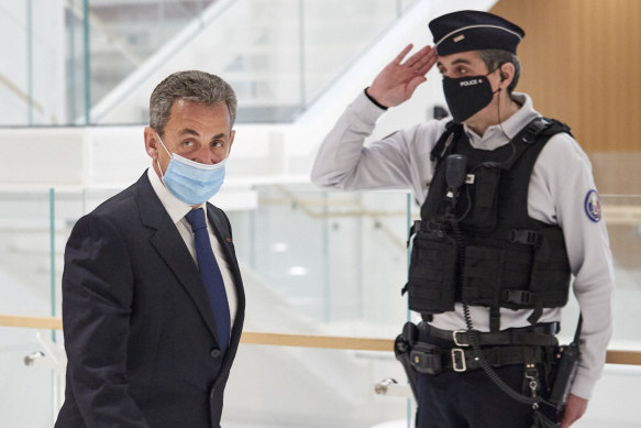 Nicolas Sarkozy leaves court after being found guilty of corruption and influence-peddling.