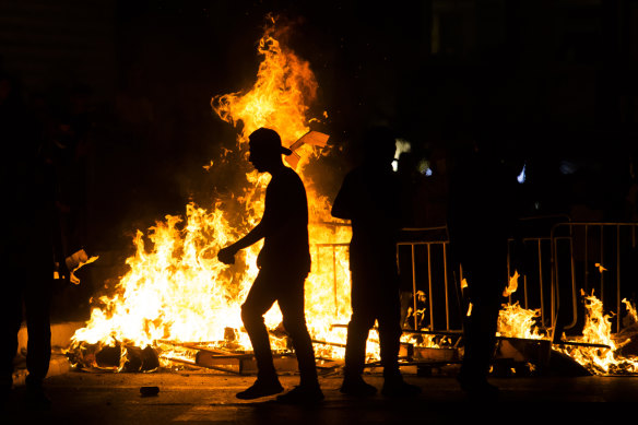 Palestinians stand next to a burning barricade during clashes with Israeli police officers on May 8.  