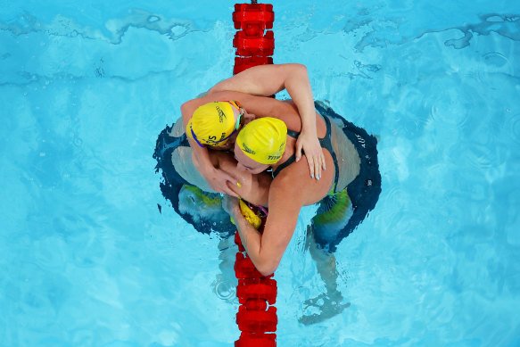 Mollie O’Callaghan and Ariarne Titmus hug after the final of the women’s 200m freestyle.