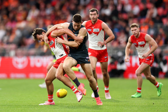 Toby Greene of the Giants competes with Oliver Florent of the Swans.