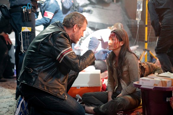 Dr House (Hugh Laurie) attends to a patient in the medical series House.