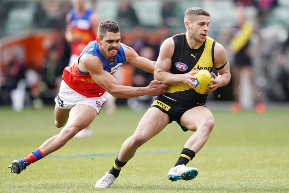 Charlie Cameron chases Dion Prestia.