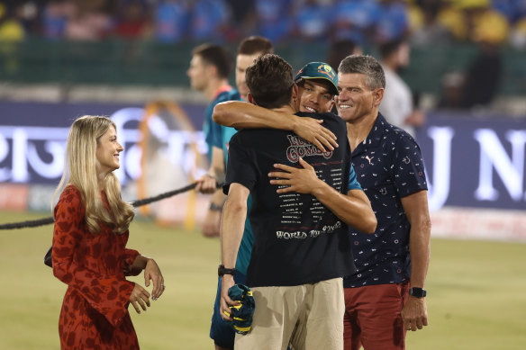 Chris Green hugs family members after receiving his debutant cap at the start of the game four of the T20 international series between India and Australia. 