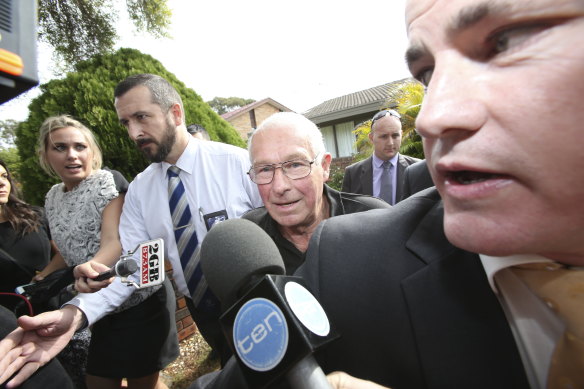 Detectives take Roger Rogerson (centre) from his home in Padstow Heights in 2014.