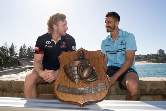 Friends or foes? Rebels skipper Brad Wilkin and NSW captain Jake Gordon at Coogee beach on Friday afternoon with the Weary Dunlop Shield.