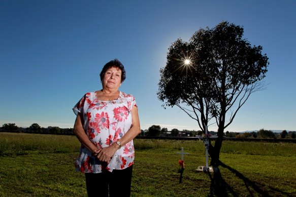 Michelle Bright’s mother Loraine, pictured in 2014, stands at a roadside memorial for her daughter.