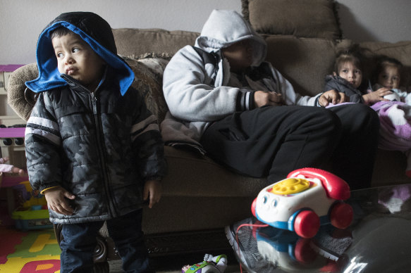 Eithan Colindres wears a winter coat inside the apartment his family lives in after they lost power during snowfall in Houston last week.