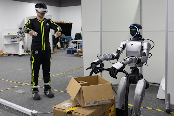 A robot is trained to carry a box.