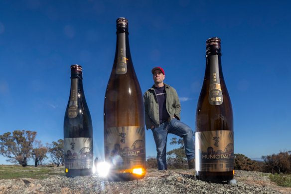 Matt Froude produces wine at Elgo Winery near Seymour. He is pictured with the Municipal Sake bottles he made in Japan.