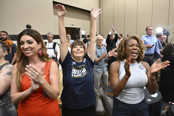 People applaud during a primary watch party in Overland Park, Kansas. State voters rejected a ballot measure  in the conservative state with deep ties to the anti-abortion movement.