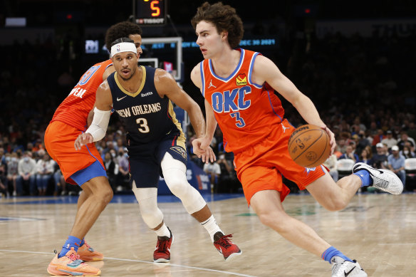 Oklahoma City Thunder guard Josh Giddey drives the ball past New Orleans Pelicans guard Josh Hart. 