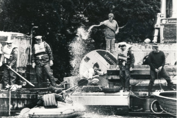 A HEC bulldozer driver uses a high-pressure hose on anti-dam protesters at Warners Landing.