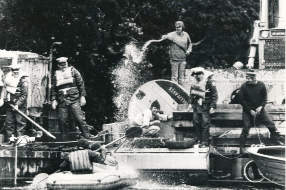 A HEC bulldozer driver uses a high-pressure hose on anti-dam protesters at Warners Landing.