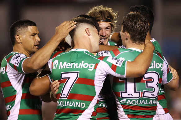 Rabbitohs halfback Lachlan Ilias celebrates a try with teammates.