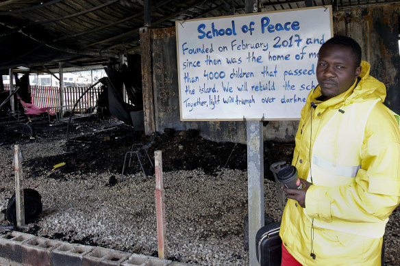 A volunteer music teacher in the burnt facilities of the school for refugee children, part of the "One Happy Family" NGO's project on the island of Lesbos on March 8, 2020.