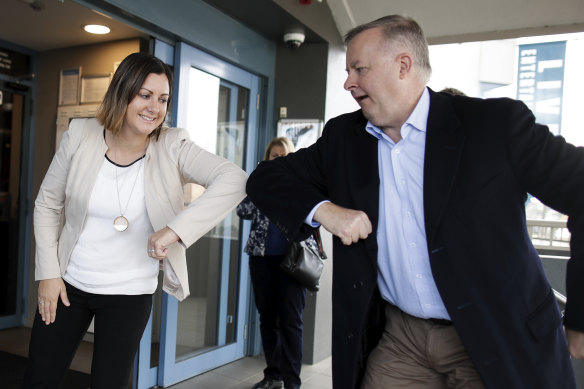 Kristy McBain, Labor candidate for Eden-Monaro, is greeted with an elbow tap by Opposition Leader Anthony Albanese during their visit to Merimbula.