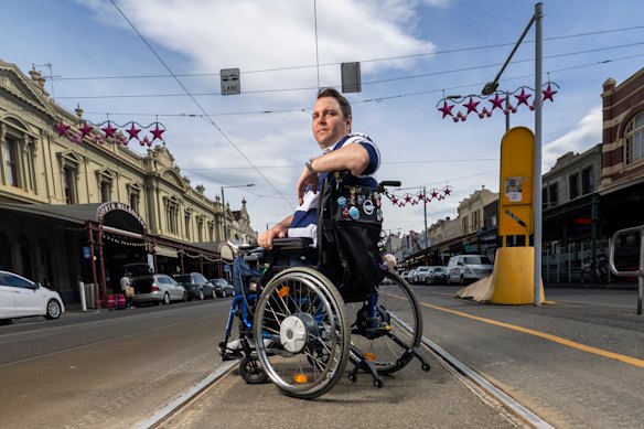 Disability advocate Andrew Bretherton at a North Melbourne tram stop without a level-access platform. 
