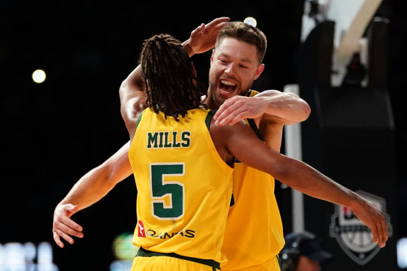 Patty Mills and Andrew Dellavedova celebrate Australia's shock win over the USA.
