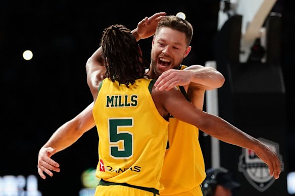 Patty Mills and Andrew Dellavedova celebrate Australia's shock win over the USA.