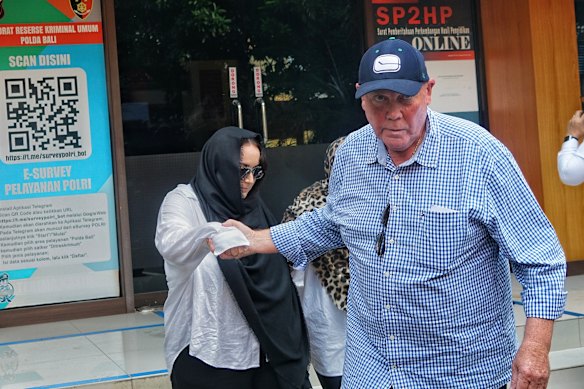 Consultant John McLeod leads family members of drug accused Lamar Ahchee as they leave police headquarters in Bali. 
