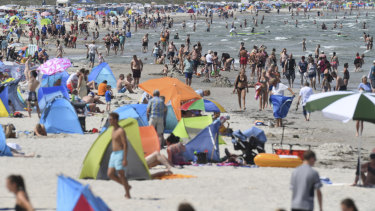 People crowd the beach at the Baltic Sea in Binz, Germany.