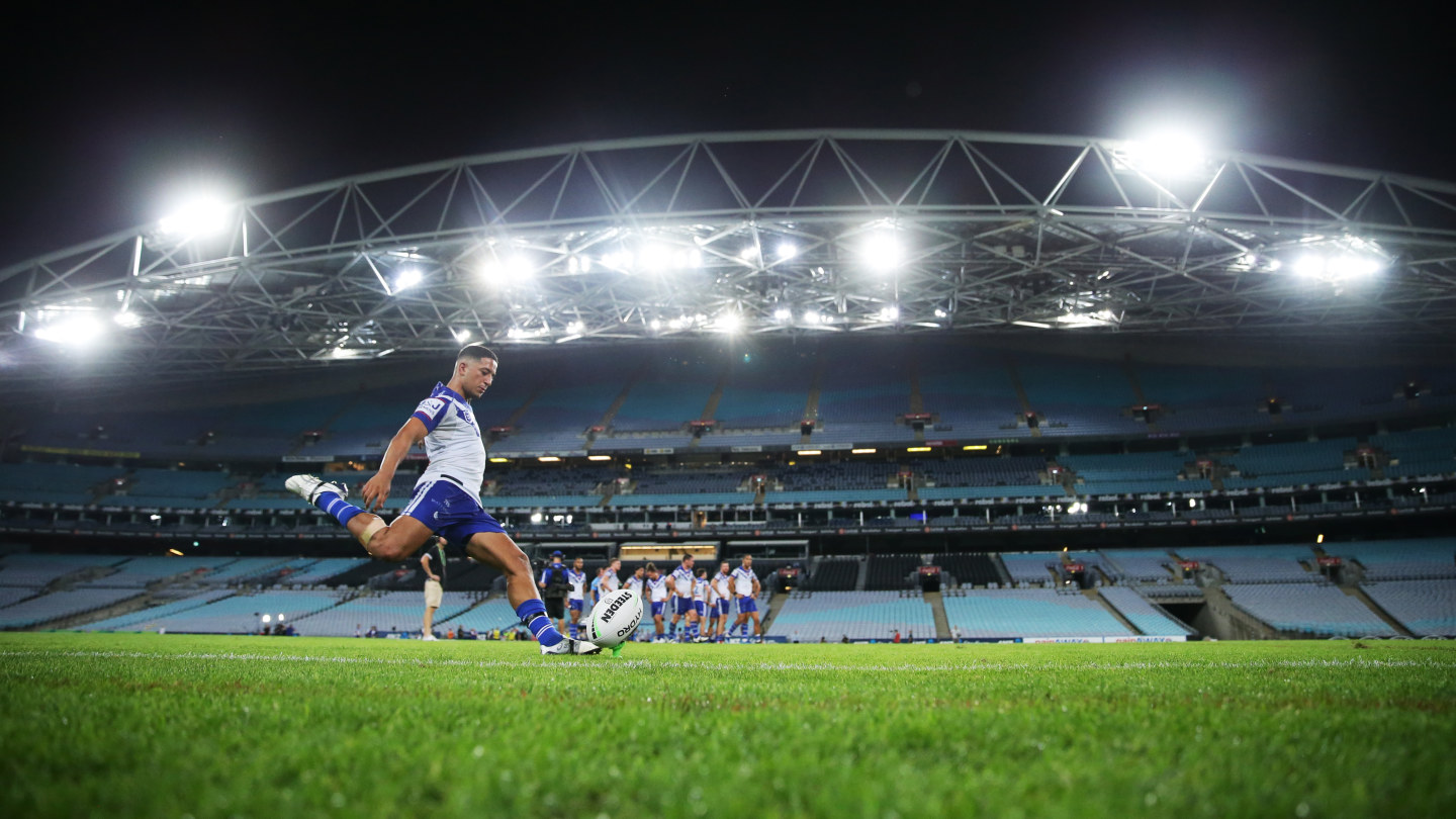 A rugby league match is being played in front of an empty stadium in Sydney on March 19 as Brendon Wakeham of the Bulldogs takes a conversion attempt. 