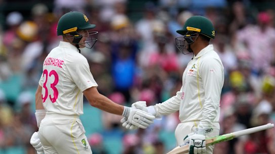 Usman Khawaja (right) congratulates Marnus Labuschagne on his half-century shortly before himself following suit.