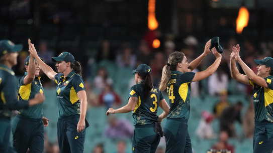 Australian players celebrate their win over England in their Women’s Ashes T20 cricket match in Sydney