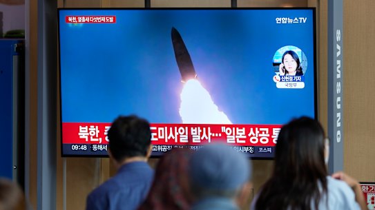 A TV screen showing a news program reporting about North Korea’s missile launch with file footage, is seen at the Seoul Railway Station in Seoul.