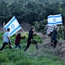 Right-wing Israeli settlers walk in the direction of the Israel-Gaza border during a rally near the Kibbutz Kfar Aza in southern Israel on February 5, 2026.