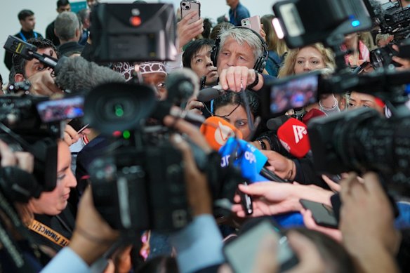 Members of the media try to interview Mohamed Adow, director of the think tank Power Shift Africa, during the COP29 U.N. Climate Summit, Saturday in Azerbaijan.