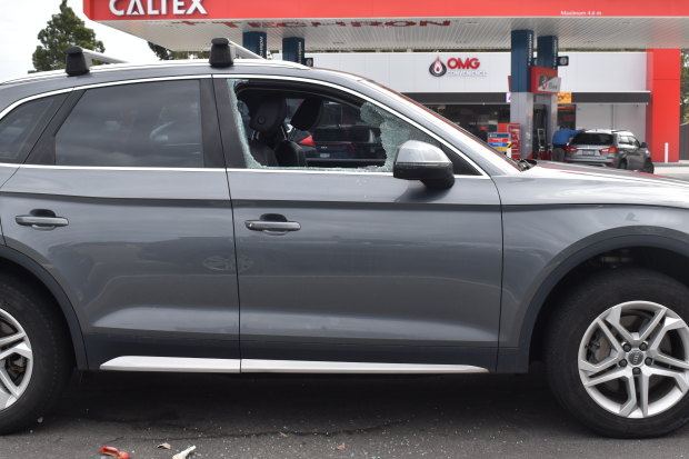 A car with a smashed window at the local shopping centre.