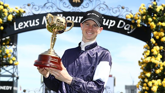 Jockey Jye McNeil with the Melbourne Cup. 