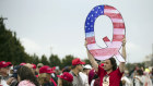 A Donald Trump supporter holds up a QAnon sign at a rally in 2018.