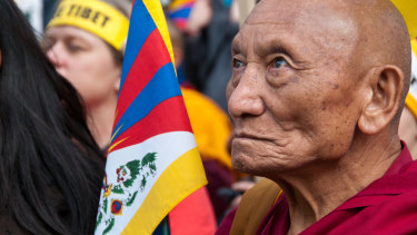 Palden Gyatso with a Tibetan flag at the Tibet Freedom March in London in 2015, the 50th anniversary of the Tibetan People's Uprising.