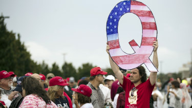 Trump supporter David Reinert holds a Q sign waits in line with others to enter a rally with President Donald Trump in Wilkes-Barre, Pennsylvania. 