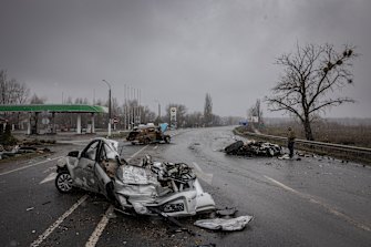 Cars lay crushed in the middle of the main road leading out of Bucha, Ukraine, on Sunday.